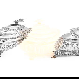 A LARGE GEORGE IV SILVER TEA CADDY: A LARGE GEORGE IV SILVER TEA CADDY by Rebecca Emes & Edward Barnard I, London 1823, of oval form with a flush-hinged domed cover, chased with fluting and with an applied border of flowerheads and