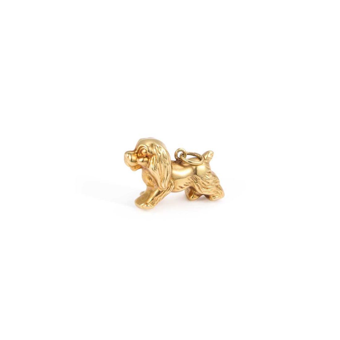 A KING CHARLES SPANIEL CHARM PENDANT: A KING CHARLES SPANIEL CHARM PENDANT stamped '585'. 2cm long, 2.5 grams Good condition
