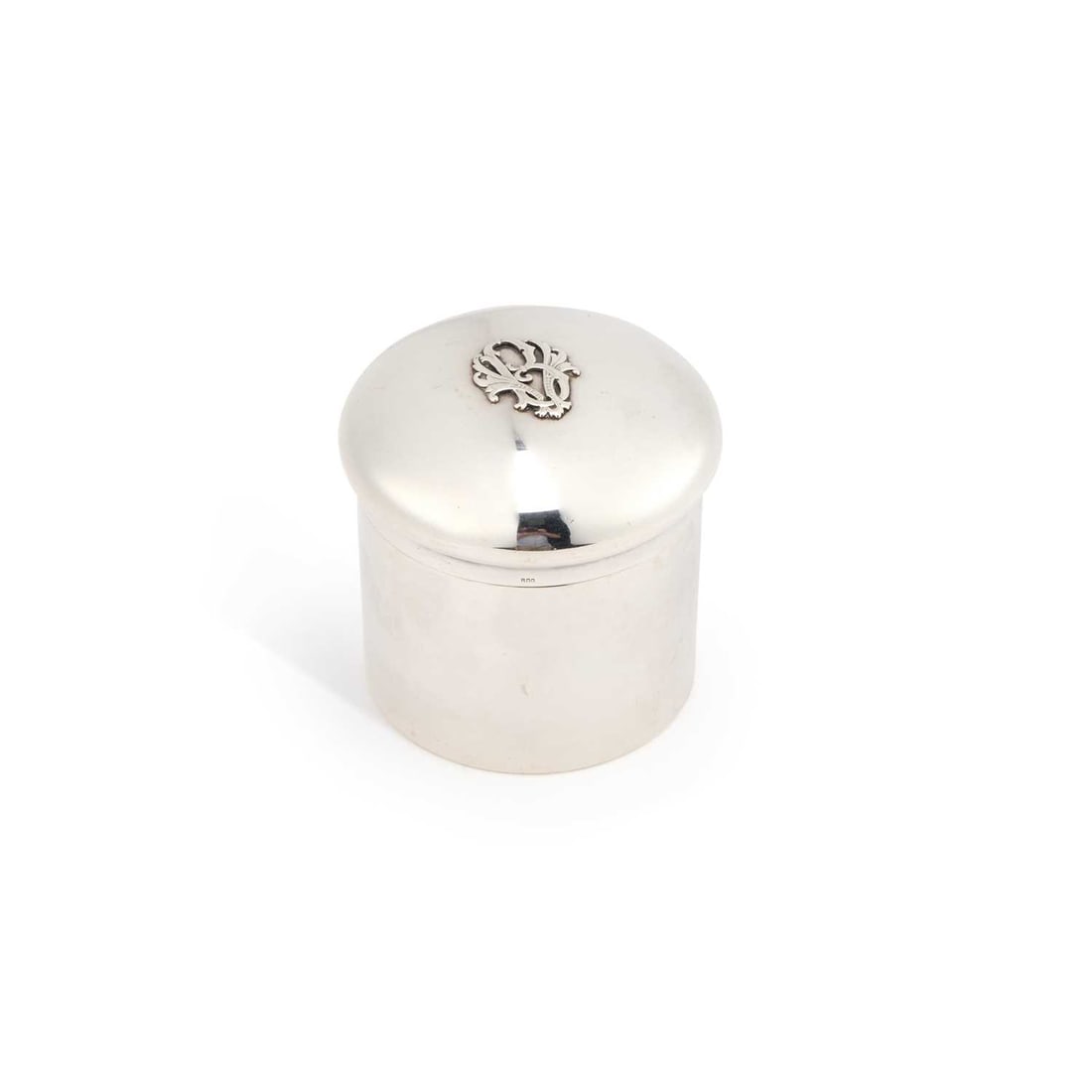 A GERMAN SILVER COSMETICS BOX: A GERMAN SILVER COSMETICS BOX 800 standard, the cylindrical jar with a domed pull-off cover centred by an applied monogram. 8cm high, 4.9 troy ounces