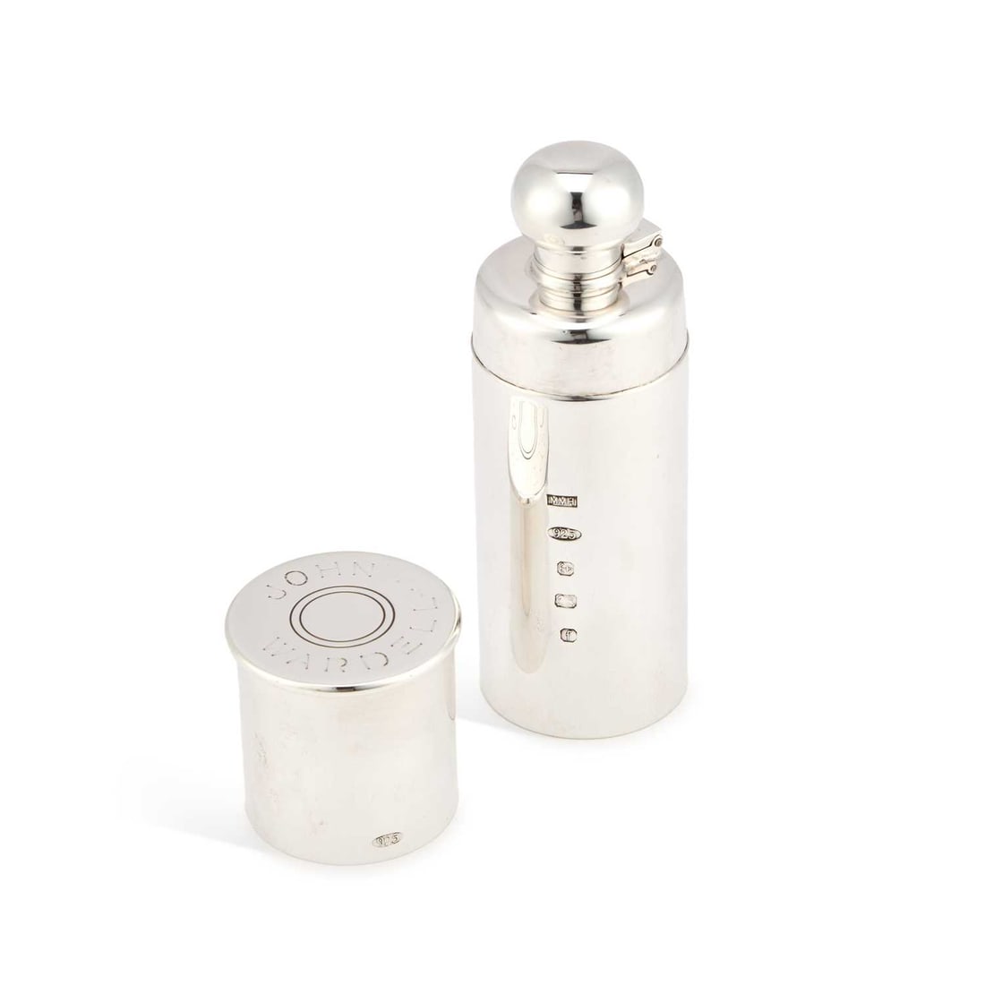 AN ELIZABETH II SILVER NOVELTY SPIRIT FLASK: AN ELIZABETH II SILVER NOVELTY SPIRIT FLASK maker M M H, Birmingham 2005, in the form of a shotgun cartridge, the cover revealing a bayonet top, inscribed to the cover JOHN WARDELL. 14.5cm high, 8 tro
