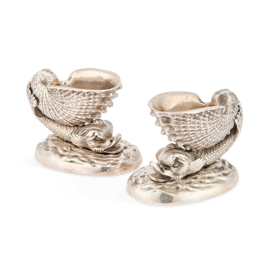 A PAIR OF HEAVY VICTORIAN CAST SILVER SALTS AFTER THE MODEL BY BENJAMIN SMITH: A PAIR OF HEAVY VICTORIAN CAST SILVER SALTS AFTER THE MODEL BY BENJAMIN SMITH by John Knowles & Son, Sheffield 1841, each modelled as a classical dolphin supporting a shell upon its back with its