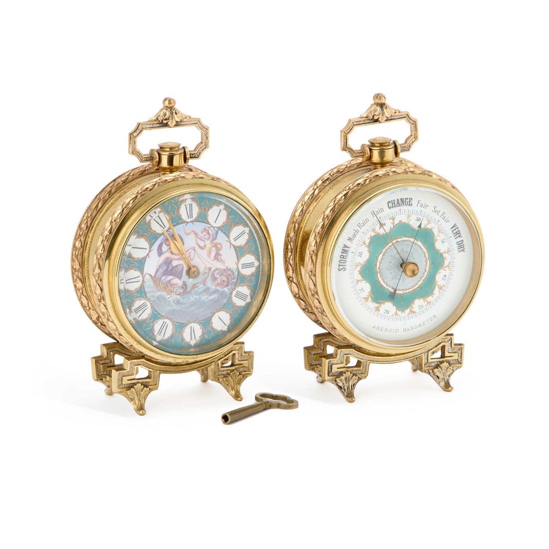 A FRENCH BRASS-CASED WEATHER STATION CIRCA 1900: A FRENCH BRASS-CASED WEATHER STATION CIRCA 1900 comprising a clock and an aneroid barometer, each in a circular case with a hinged carrying handle and foliate bands, raised on bracket feet with leaf-c
