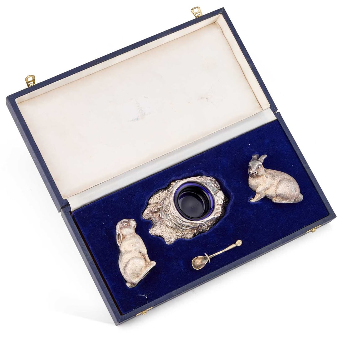 AN ELIZABETH II SILVER NOVELTY CONDIMENT SET: AN ELIZABETH II SILVER NOVELTY CONDIMENT SET by Richard Comyns, London 1990, the salt and pepper shaker each formed as a rabbit, one sitting upright and the other crouching, the mustard pot formed as