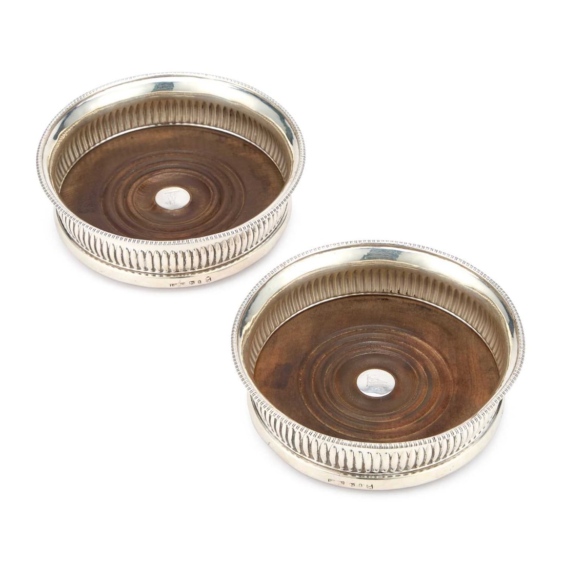 A PAIR OF GEORGE III SILVER WINE COASTERS: A PAIR OF GEORGE III SILVER WINE COASTERS by John Green, Roberts, Mosley & Co, Sheffield 1802, each of circular form with a bead-and-reel rim above reeded rounded sides, the turned wooden bases wi