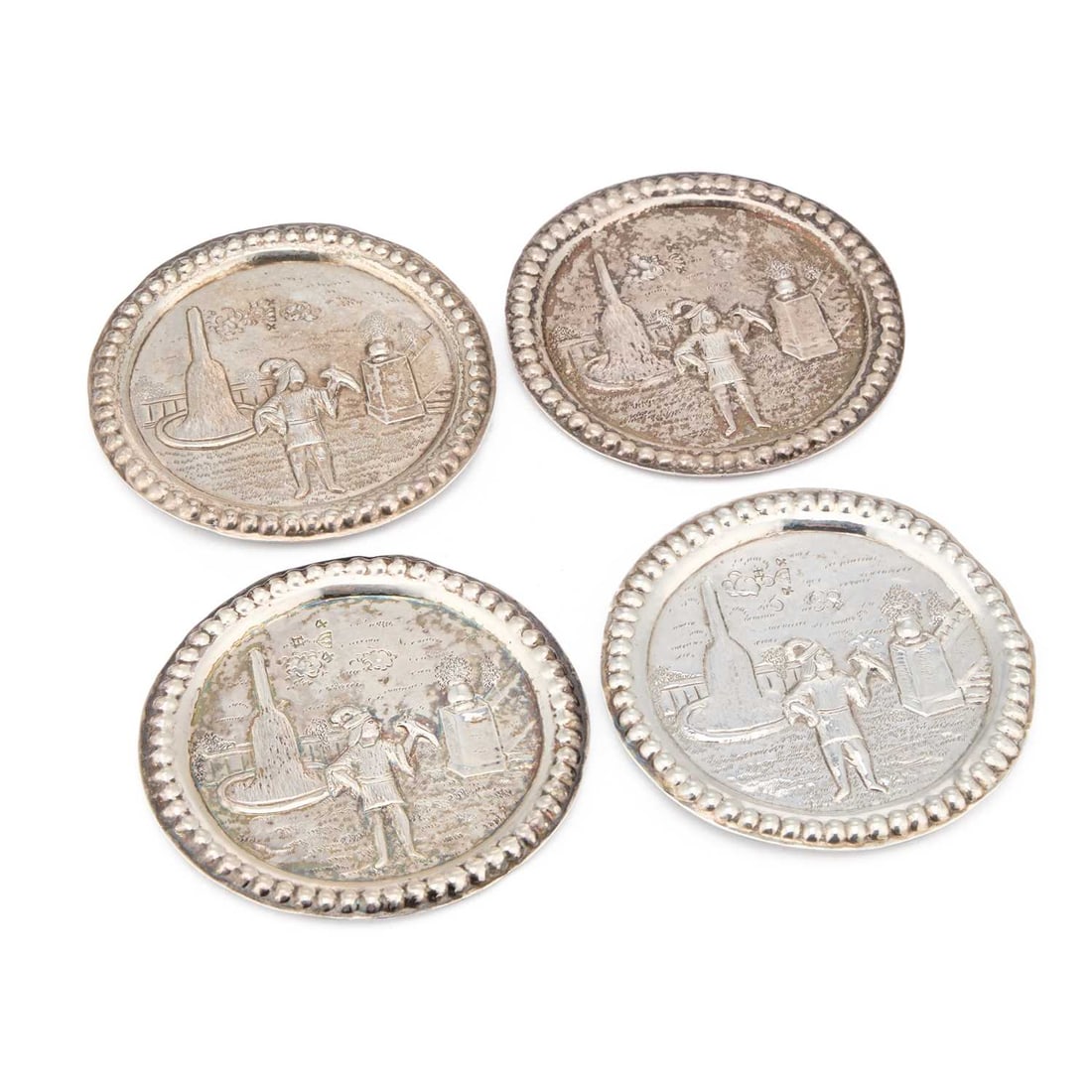 A SET OF FOUR DUTCH SILVER COASTERS: A SET OF FOUR DUTCH SILVER COASTERS with thistle control mark, each of circular form with a beaded rim enclosing a chased scene of a man holding a bird. (4) 9cm diameter, 4.5 troy ounces gross