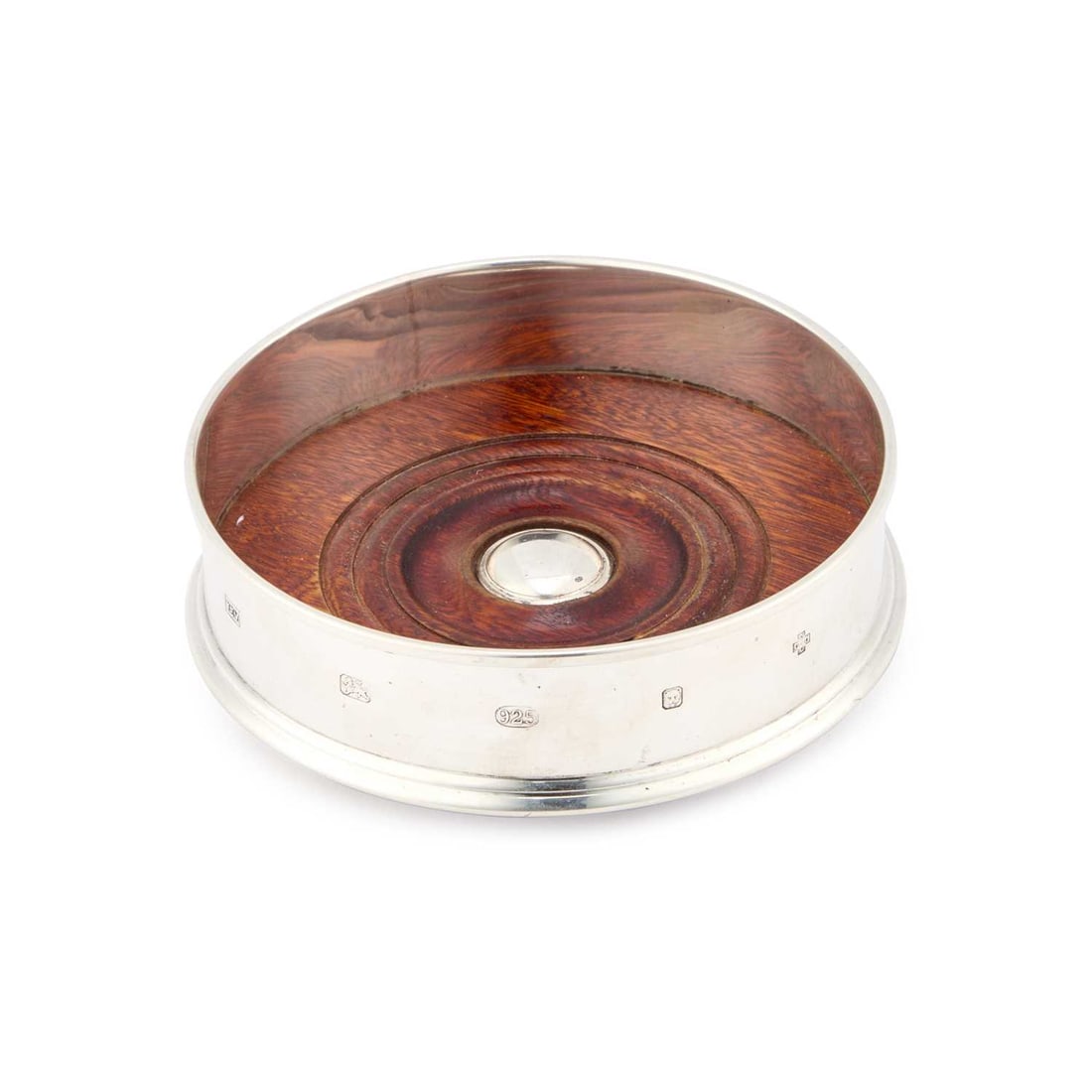 AN ELIZABETH II SILVER WINE COASTER: AN ELIZABETH II SILVER WINE COASTER by W.E.V., London 2000, in George III style, of circular form with a turned wooden base centred by a silver roundel. 13cm diameter