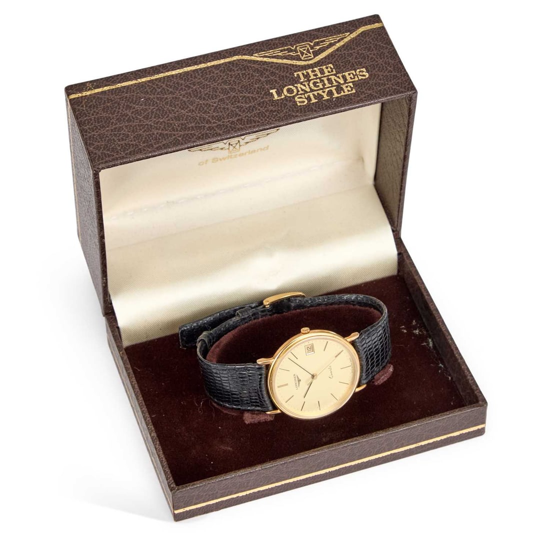 A GENTS 9CT GOLD LONGINES STRAP WATCH: A GENTS 9CT GOLD LONGINES STRAP WATCH the circular champagne dial signed Longines Quartz, with black/ gilt baton indices and hands, date aperture at the 3 o'clock position, original Longines crown, pl