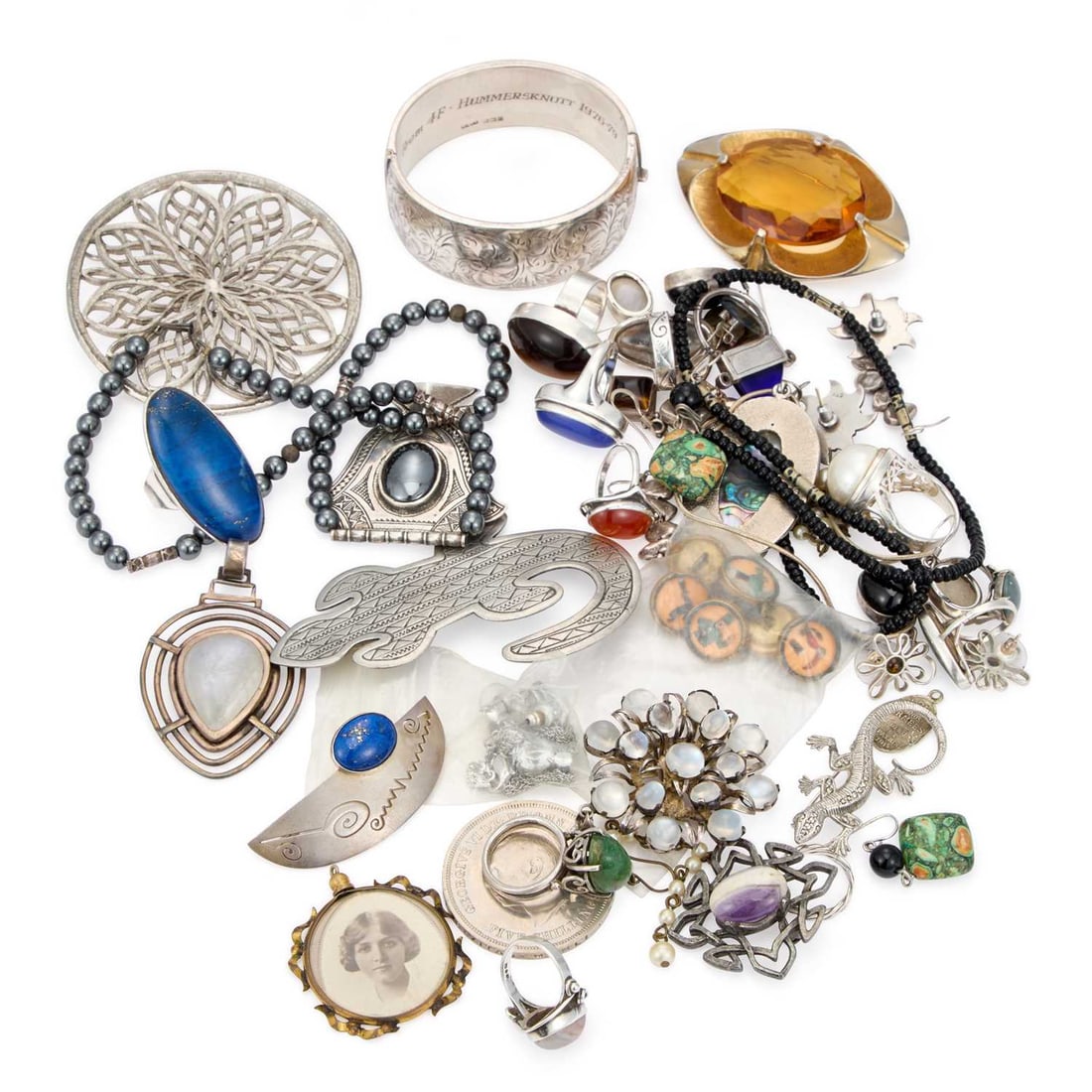 A GROUP OF SILVER AND COSTUME JEWELLERY: A GROUP OF SILVER AND COSTUME JEWELLERY including a set of six Guiness buttons, a hallmarked silver hinged bangle, a hematite Tuareg necklace, etc. (Qty) Bangle 5.8cm diameter