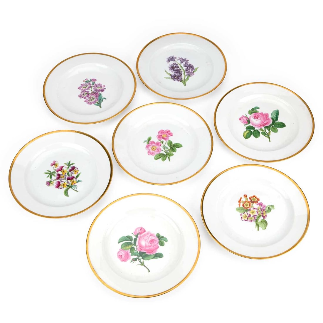A SET OF SEVEN MEISSEN PORCELAIN PLATES LATE 19TH/ EARLY 20TH CENTURY: A SET OF SEVEN MEISSEN PORCELAIN PLATES LATE 19TH/ EARLY 20TH CENTURY each outside decorated with a central botanical spray within a gilt rim, underglaze blue crossed swords marks. (7) 23.5cm diameter