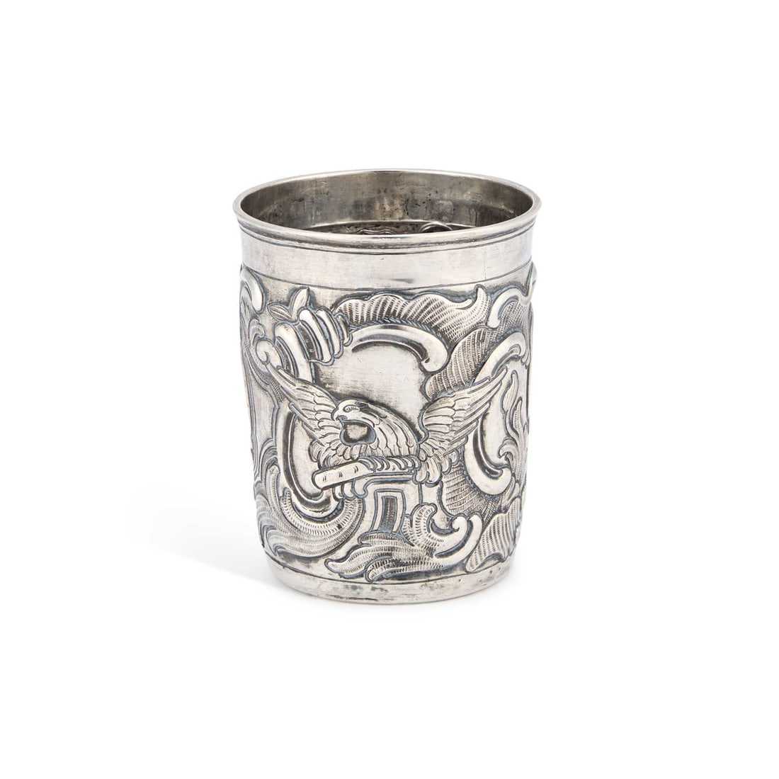 AN 18TH CENTURY RUSSIAN SILVER BEAKER: AN 18TH CENTURY RUSSIAN SILVER BEAKER Moscow 176?, with repoussé decoration of eagles, shells and scrolls. 8.5cm high, 2.5 troy ounces