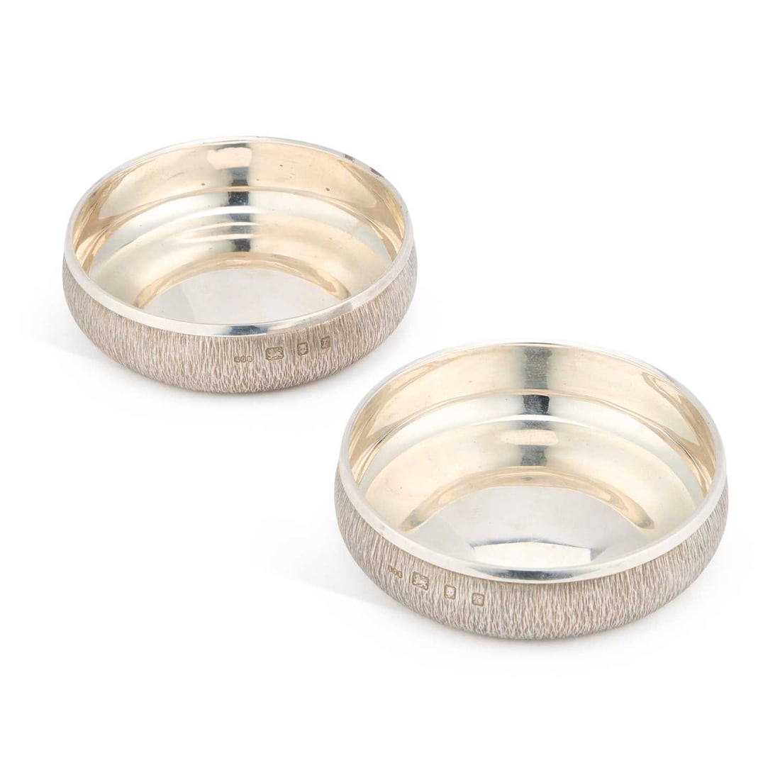 GERALD BENNEY, A PAIR OF ELIZABETH II SILVER BOWLS OR COASTERS: GERALD BENNEY, A PAIR OF ELIZABETH II SILVER BOWLS OR COASTERS by Gerald Benney, London 1972, of circular form with rounded textured sides. (2) 12.5cm diameter, 15.3 troy ounces gross
