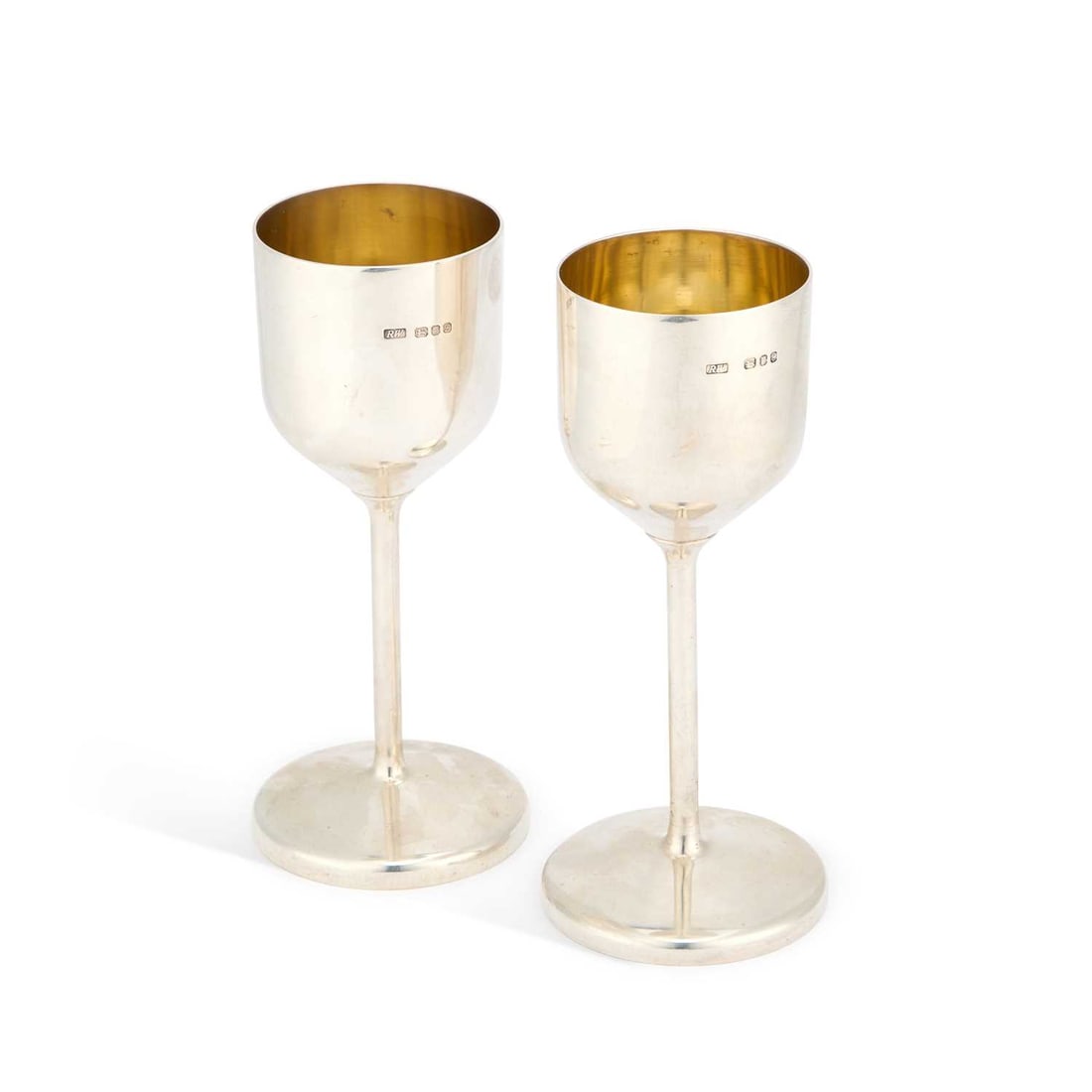 ROBERT WELCH, A PAIR OF ELIZABETH II SILVER GOBLETS: ROBERT WELCH, A PAIR OF ELIZABETH II SILVER GOBLETS by Robert Welch, London 1978 and 1979, each cylindrical bowl with a gilt-lined interior, raised on a tall slender stem issuing from a plain circular