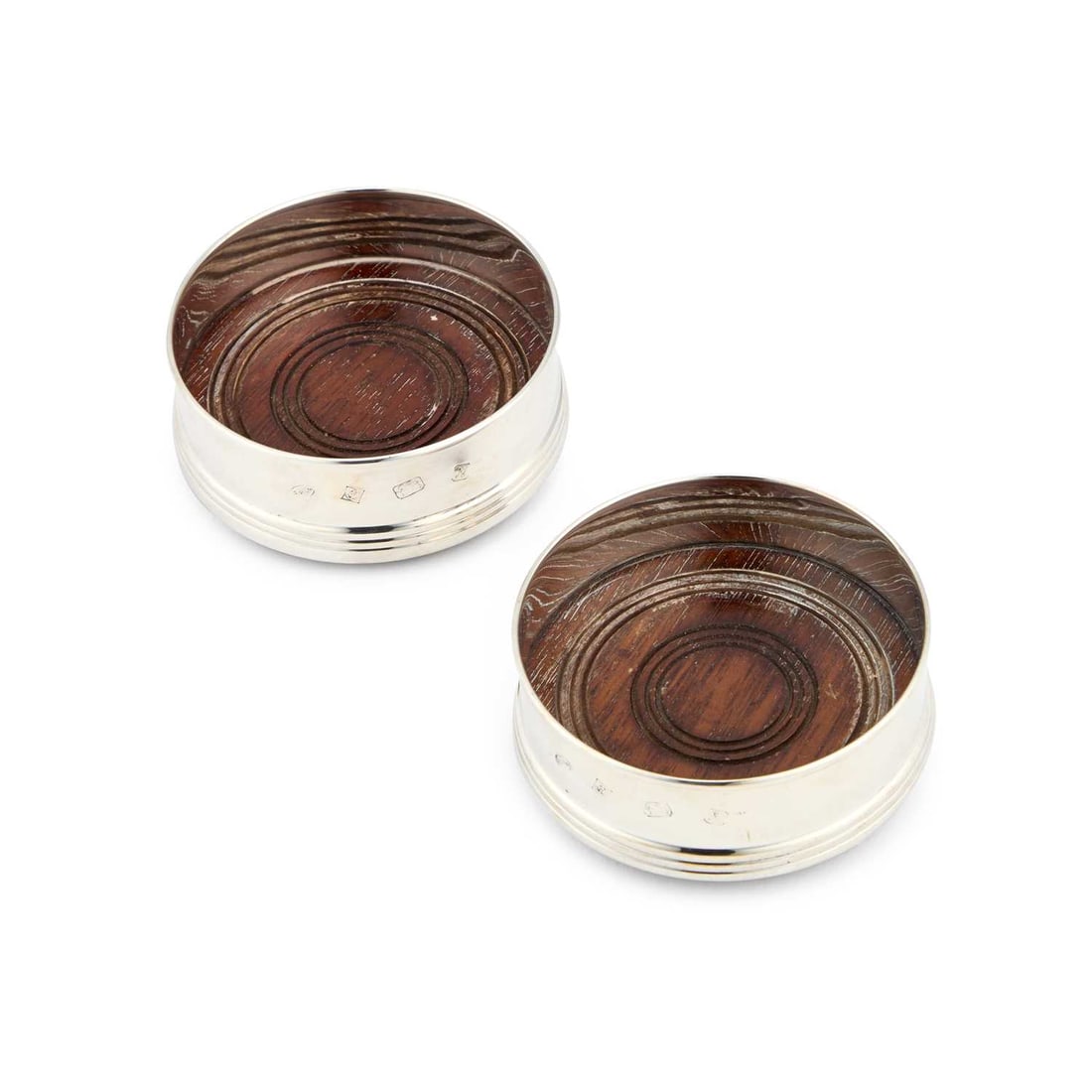 A PAIR OF ELIZABETH II SILVER-MOUNTED WINE COASTERS: A PAIR OF ELIZABETH II SILVER-MOUNTED WINE COASTERS by W I Broadway & Co, Birmingham 1987, of circular form with plain solid sides and turned wooden bases. (2) 9cm diameter