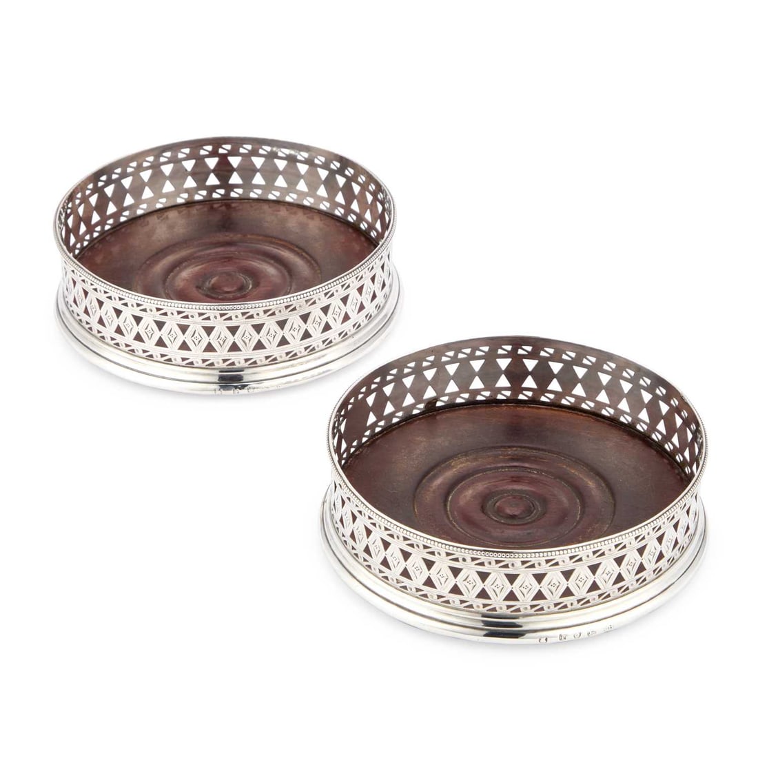 A PAIR OF GEORGE III SILVER COASTERS: A PAIR OF GEORGE III SILVER COASTERS by Robert Hennell I, London 1786, with bead rims, the sides pierced with lozenges and scrolling waves and engraved with wrigglework, each engraved with crest and m