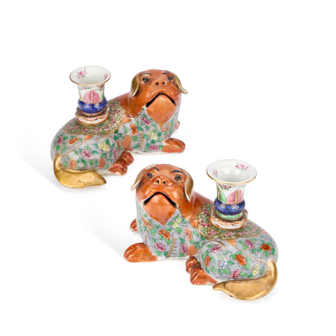 A PAIR OF CHINESE FAMILLE ROSE PORCELAIN INCENSE HOLDERS 19TH CENTURY: A PAIR OF CHINESE FAMILLE ROSE PORCELAIN INCENSE HOLDERS 19TH CENTURY each modelled as a recumbent dog, the bodies richly enamelled with dense Famille Rose floral trellis decoration, the heads and lim