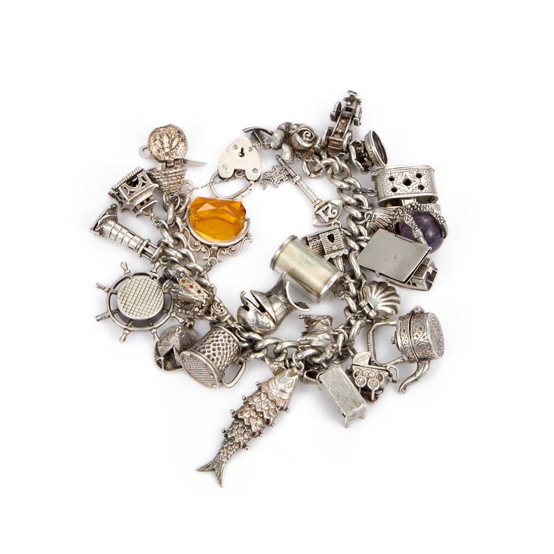 A SILVER CHARM BRACELET WITH A HEART PADLOCK CLASP: A SILVER CHARM BRACELET WITH A HEART PADLOCK CLASP the curb link chain adorned with charms including emergency money, amethyst ball and eagle claw foot, articulated tipi/ tepee with a figure inside, e