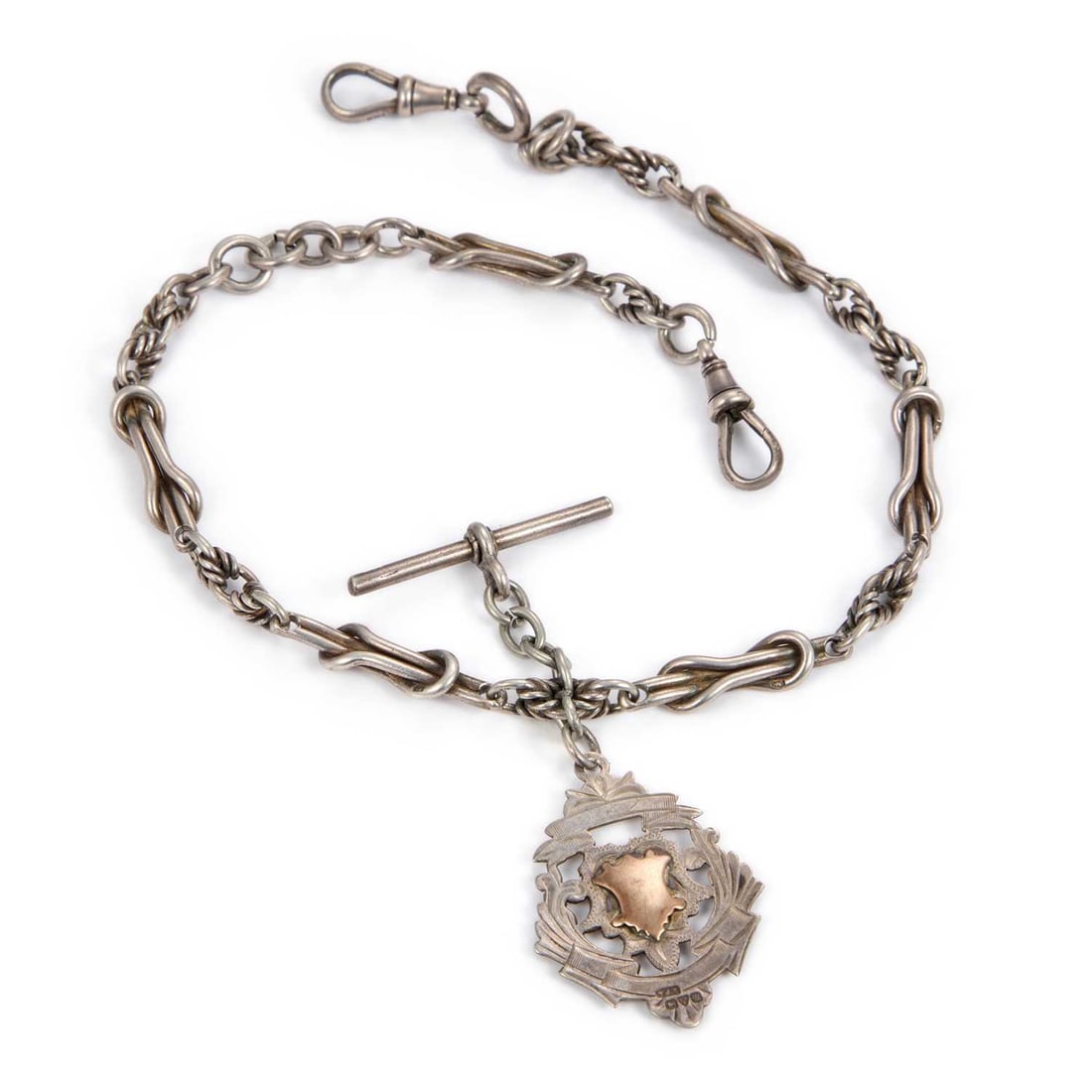 AN ANTIQUE SILVER FANCY LINK ALBERT CHAIN AND FOB: AN ANTIQUE SILVER FANCY LINK ALBERT CHAIN AND FOB each link hallmarked with a lion passant, hallmarked Birmingham 1902, the shield-shaped fob hallmarked Chester 1920, with two dog clips and a T-bar. 3