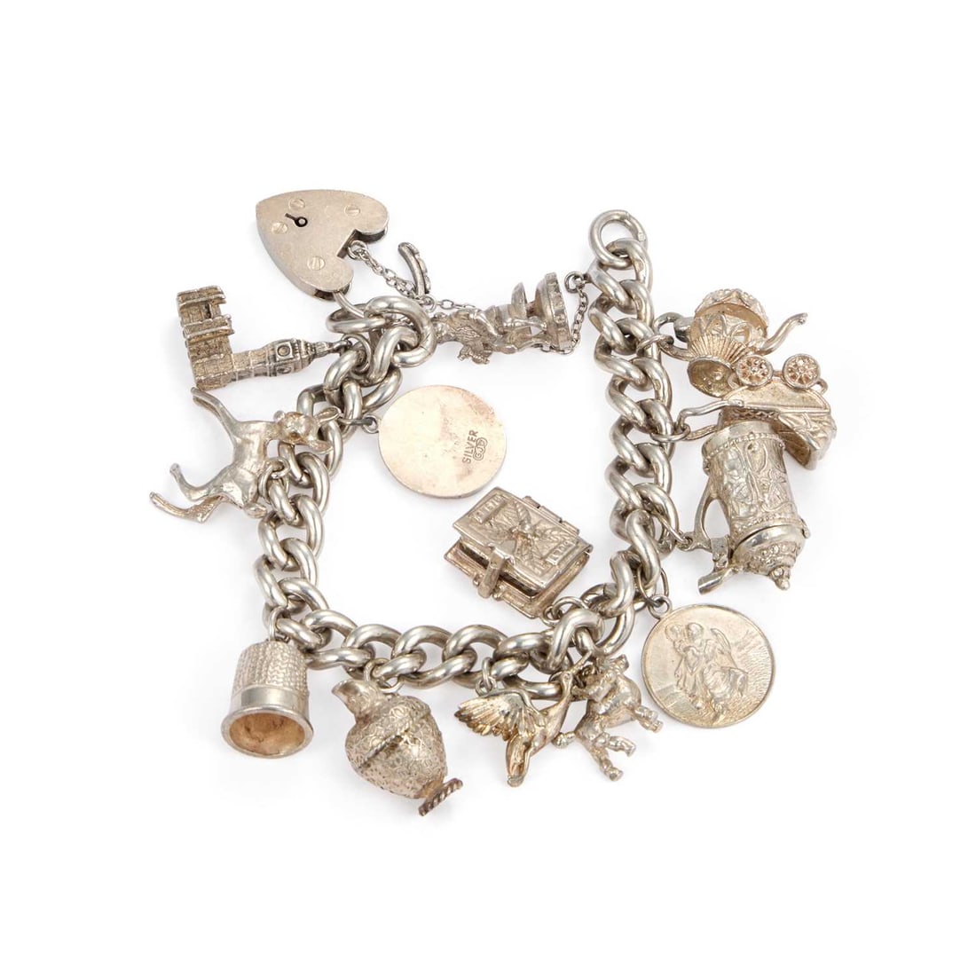 A SILVER CHARM BRACELET: A SILVER CHARM BRACELET the curb link chain with a heart padlock clasp adorned with charms including a thimble, stork and baby, etc. 18cm long (approx.), 90.7 grams