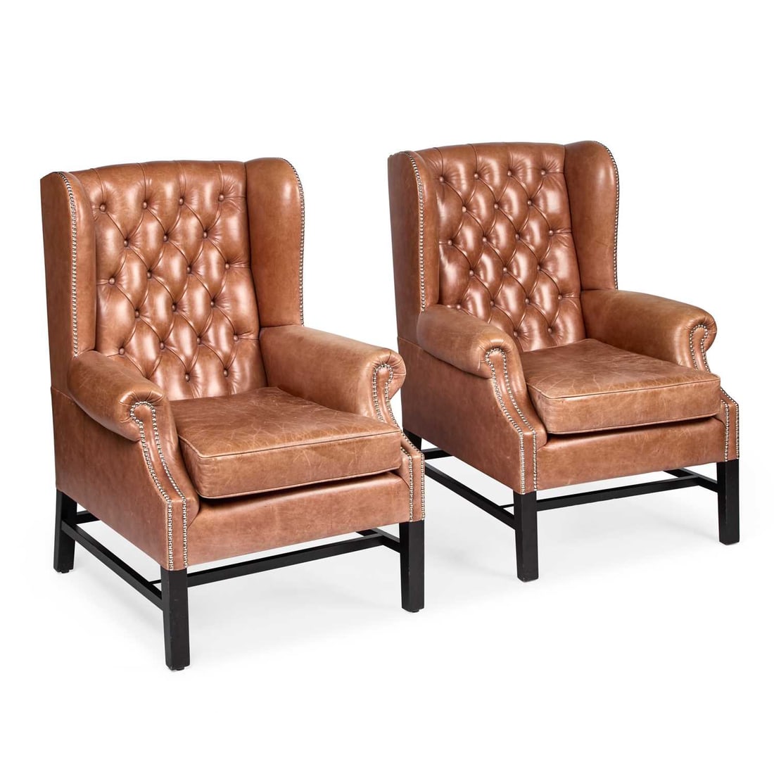A PAIR OF BROWN LEATHER UPHOLSTERED WING-BACK ARMCHAIRS (1 of 1)