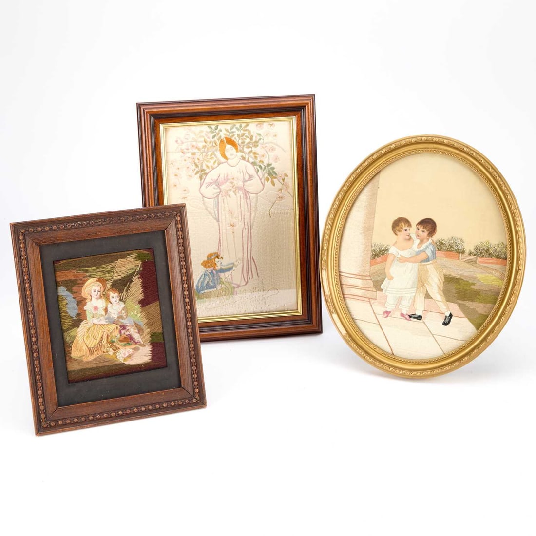 THREE SILKWORK PICTURES CIRCA 1900: THREE SILKWORK PICTURES CIRCA 1900 comprising the first of a mother and child in Art Nouveau style, framed; the two other silkworks of brothers and sisters in period costume. (3) First 34cm by 25cm
