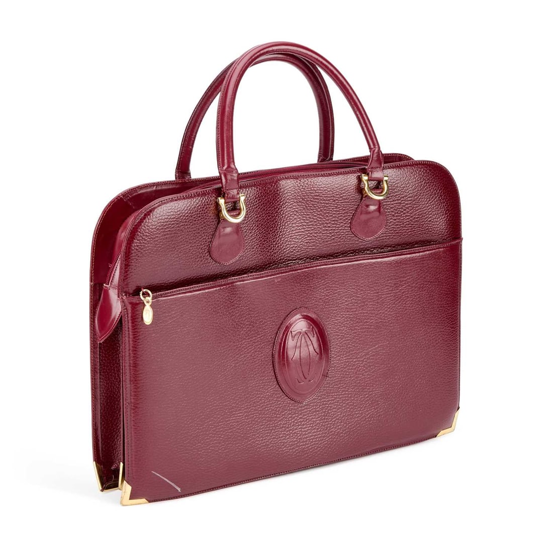 A MUST DE CARTIER BRIEFCASE: A MUST DE CARTIER BRIEFCASE burgundy leather with gold tone hardware, the front zip pocket applied with the embossed double C monogram/ logo, the interior with monogram lining and two divided