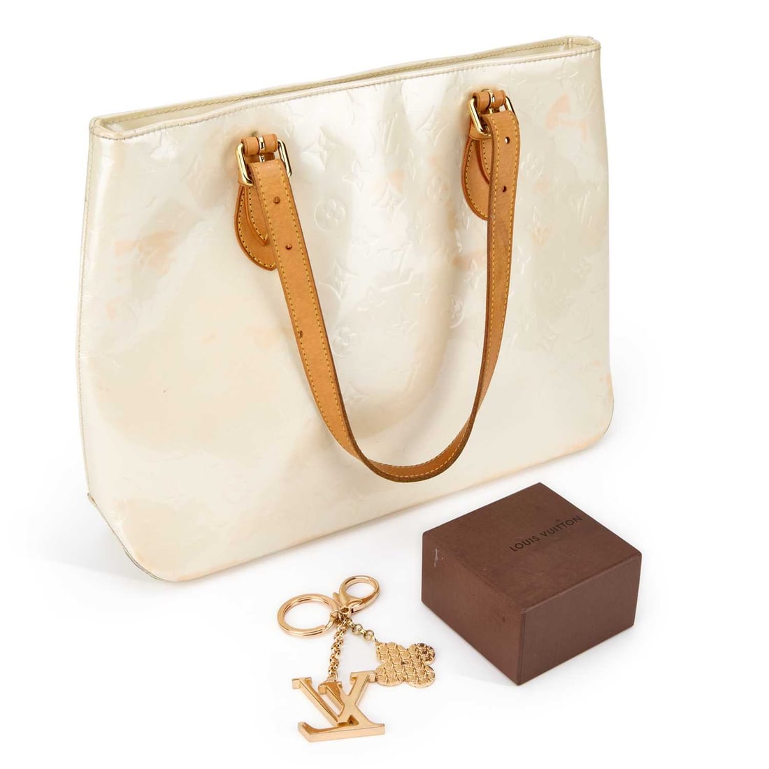 A LOUIS VUITTON BRENTWOOD TOTE BAG: A LOUIS VUITTON BRENTWOOD TOTE BAG monogram Perle Vernis patent leather, with vachetta handles and gold tone hardware, the interior with two pockets; together with a Louis Vuitton keyring, boxed. (2)