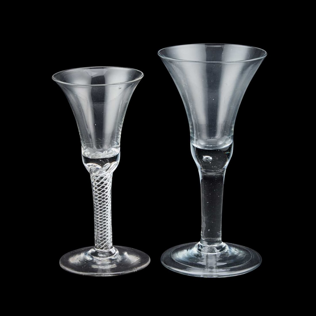 TWO LARGE GOBLETS 18TH CENTURY: TWO LARGE GOBLETS 18TH CENTURY the first with a drawn trumpet bowl rising from a plain stem enclosing a single tear, over a folded conical foot; the second with air-twist stem and plain circular foot.