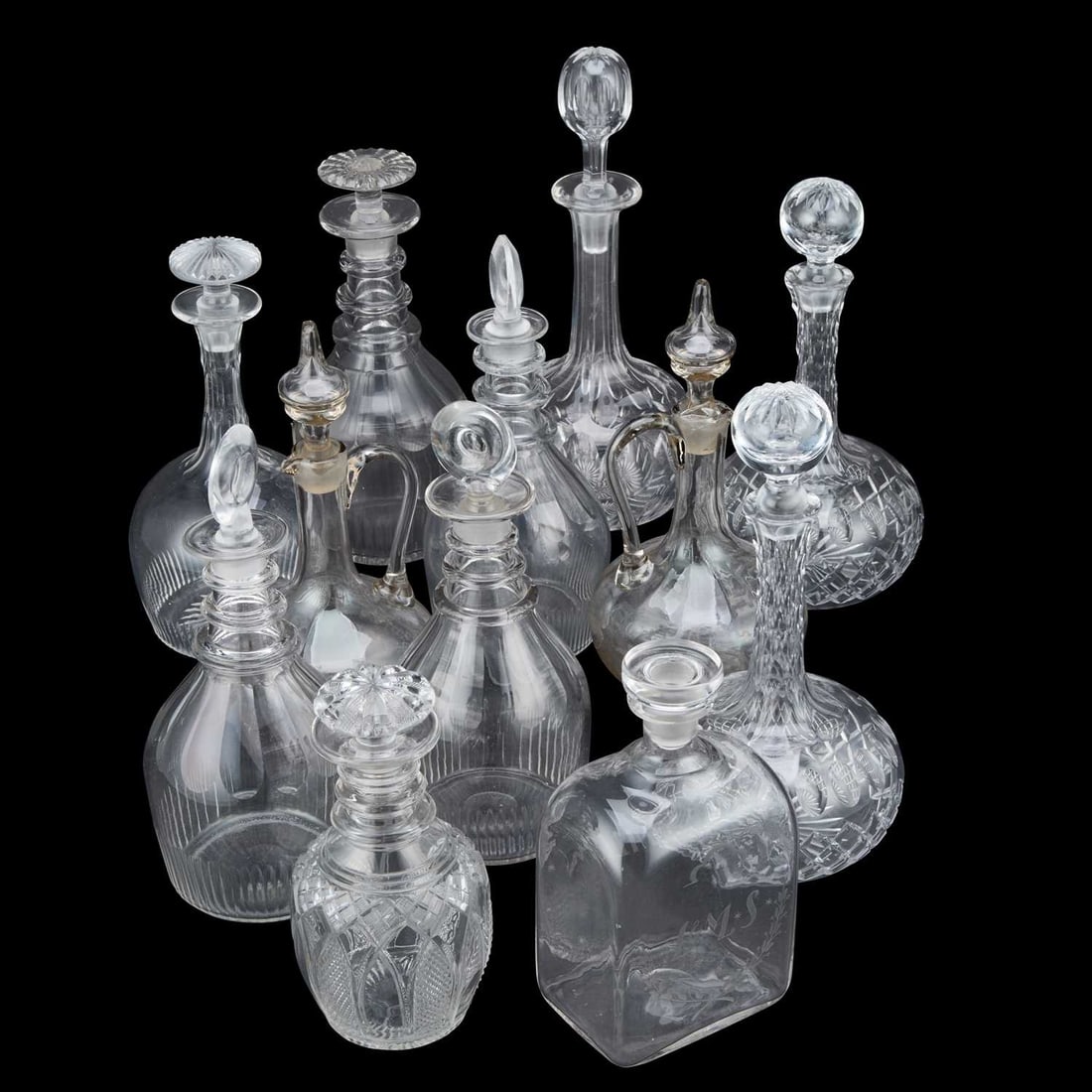 A COLLECTION OF TWELVE DECANTERS AND CLARET JUGS EARLY 19TH CENTURY AND LATER: A COLLECTION OF TWELVE DECANTERS AND CLARET JUGS EARLY 19TH CENTURY AND LATER (12) Tallest 32cm