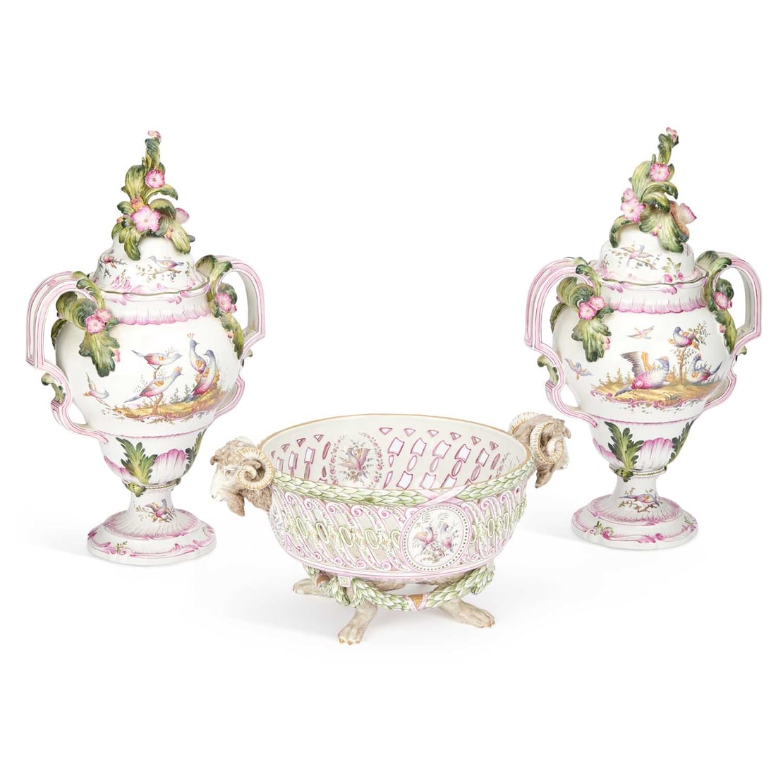A FRENCH FAIENCE GARNITURE CIRCA 1880: A FRENCH FAIENCE GARNITURE CIRCA 1880 comprising of a pair of twin handled vases and covers, well painted with exotic birds, within moulded rococo scrollwork, heightened in puce enamel, the covers wit