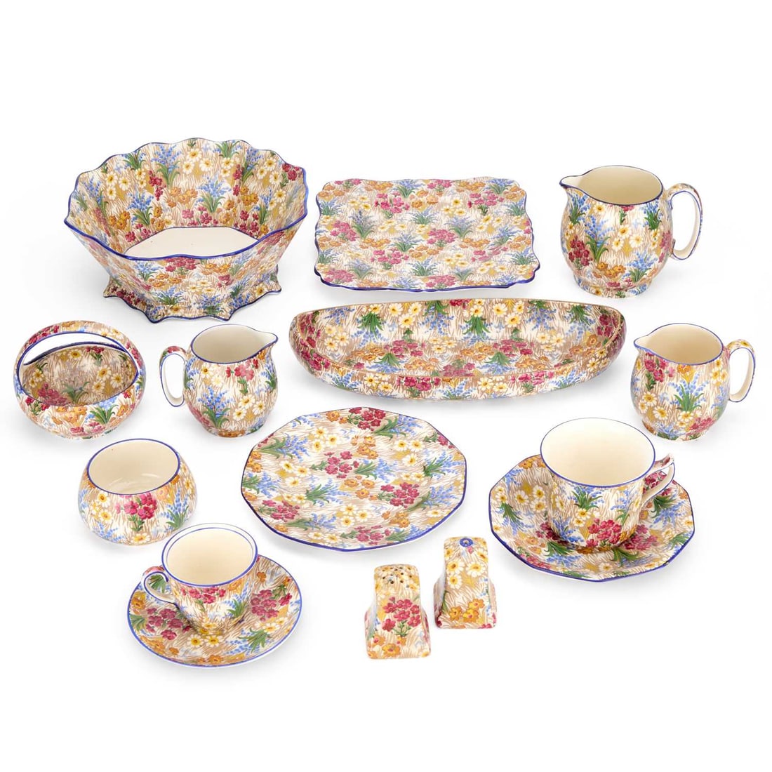 A GROUP OF GRIMWADES CHINTZ WARES CIRCA 1930: A GROUP OF GRIMWADES CHINTZ WARES CIRCA 1930 comprising jugs, bowls, salt and pepper pots, plates and a basket (15 pieces); together with a Susie Cooper jug, two large cups, and Crown Ducal teawares, 
