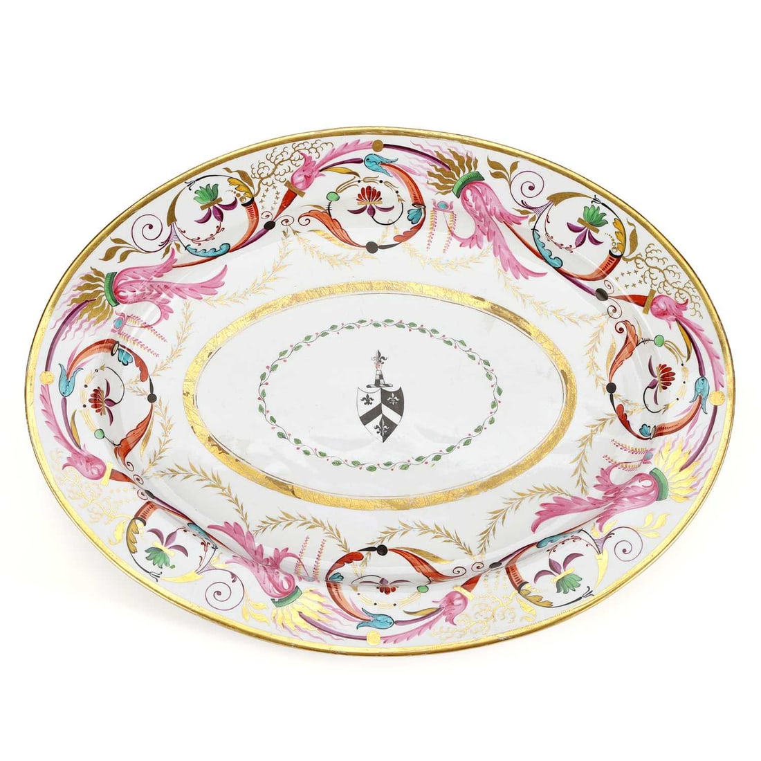 A BARR FLIGHT & BARR PORCELAIN SERVING DISH CIRCA 1810: A BARR FLIGHT & BARR PORCELAIN SERVING DISH CIRCA 1810 oval form, vibrantly painted with linked sheafs of pink and gold leaves surrounding an armorial shield within a wide gilt oval, probably the arms