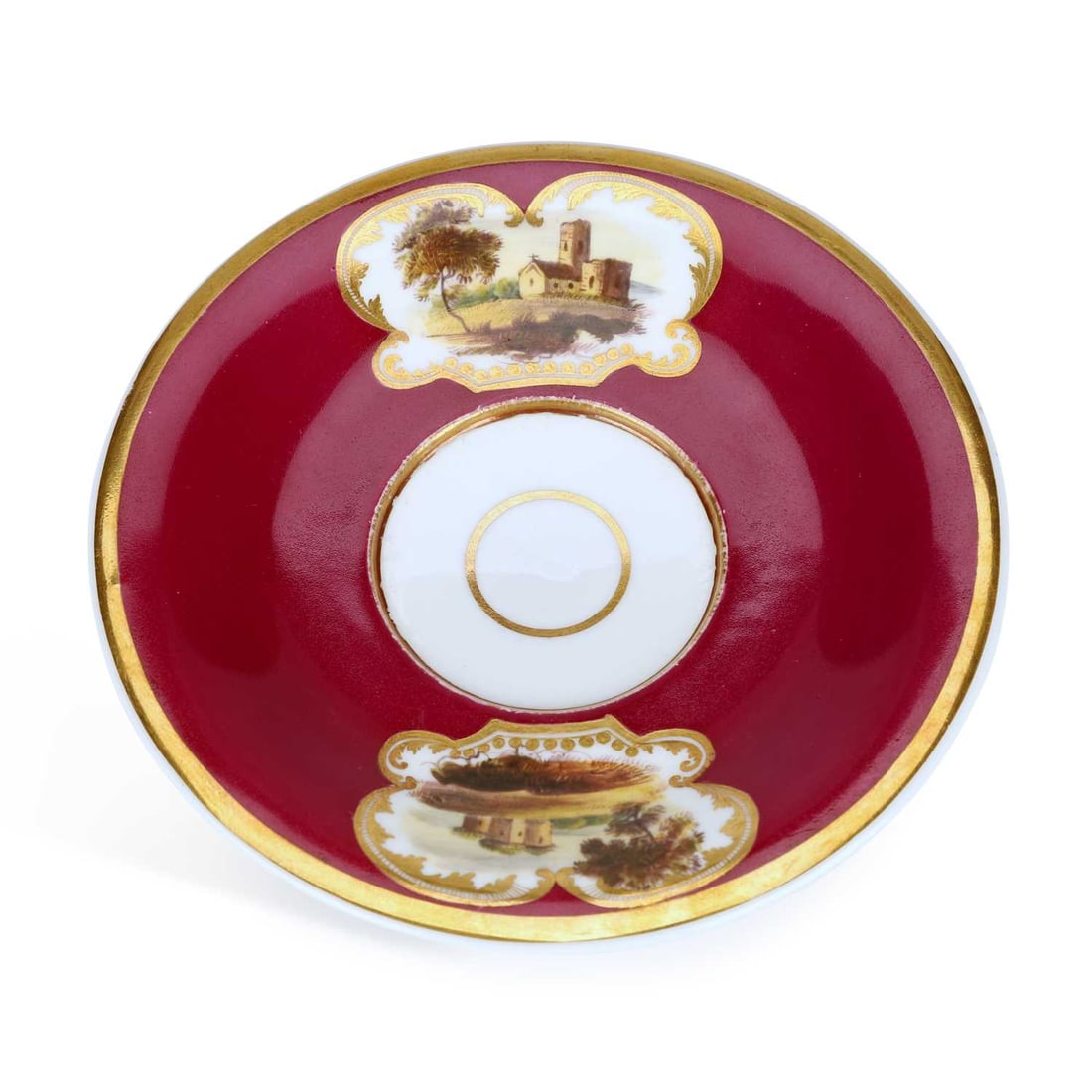A ROCKINGHAM PORCELAIN CAUDLE CUP STAND CIRCA 1830: A ROCKINGHAM PORCELAIN CAUDLE CUP STAND CIRCA 1830 the claret ground stand with a gilt rim, hand painted with two landscape scenes within chased gilt surrounds, red griffin mark and CI 7 in gilt. 12cm