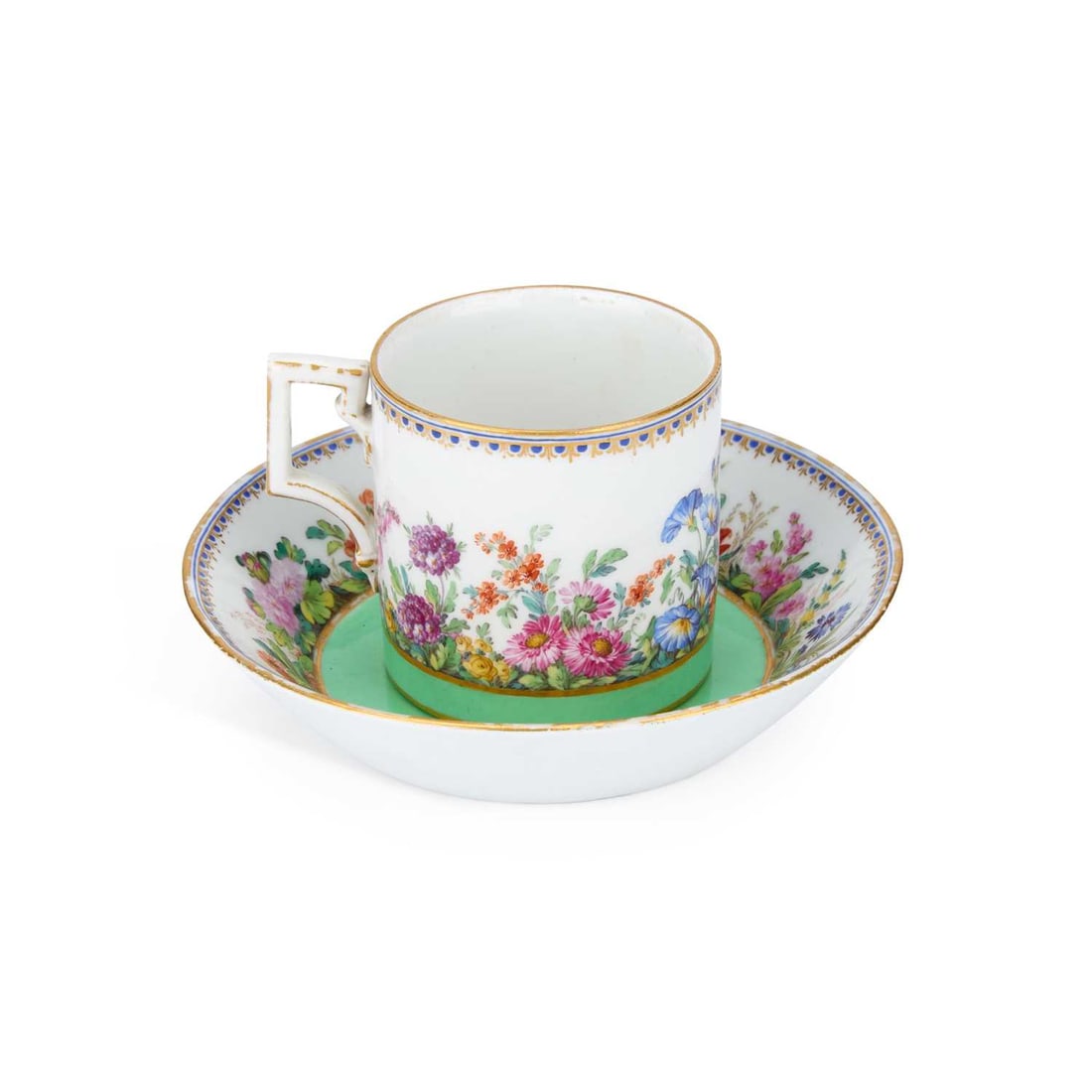 A BERLIN PORCELAIN COFFEE CAN AND SAUCER CIRCA 1820: A BERLIN PORCELAIN COFFEE CAN AND SAUCER CIRCA 1820 the can finely painted with a continuous scene of flowering plants, above a green band, with an angular handle, the saucer similarly decorated,