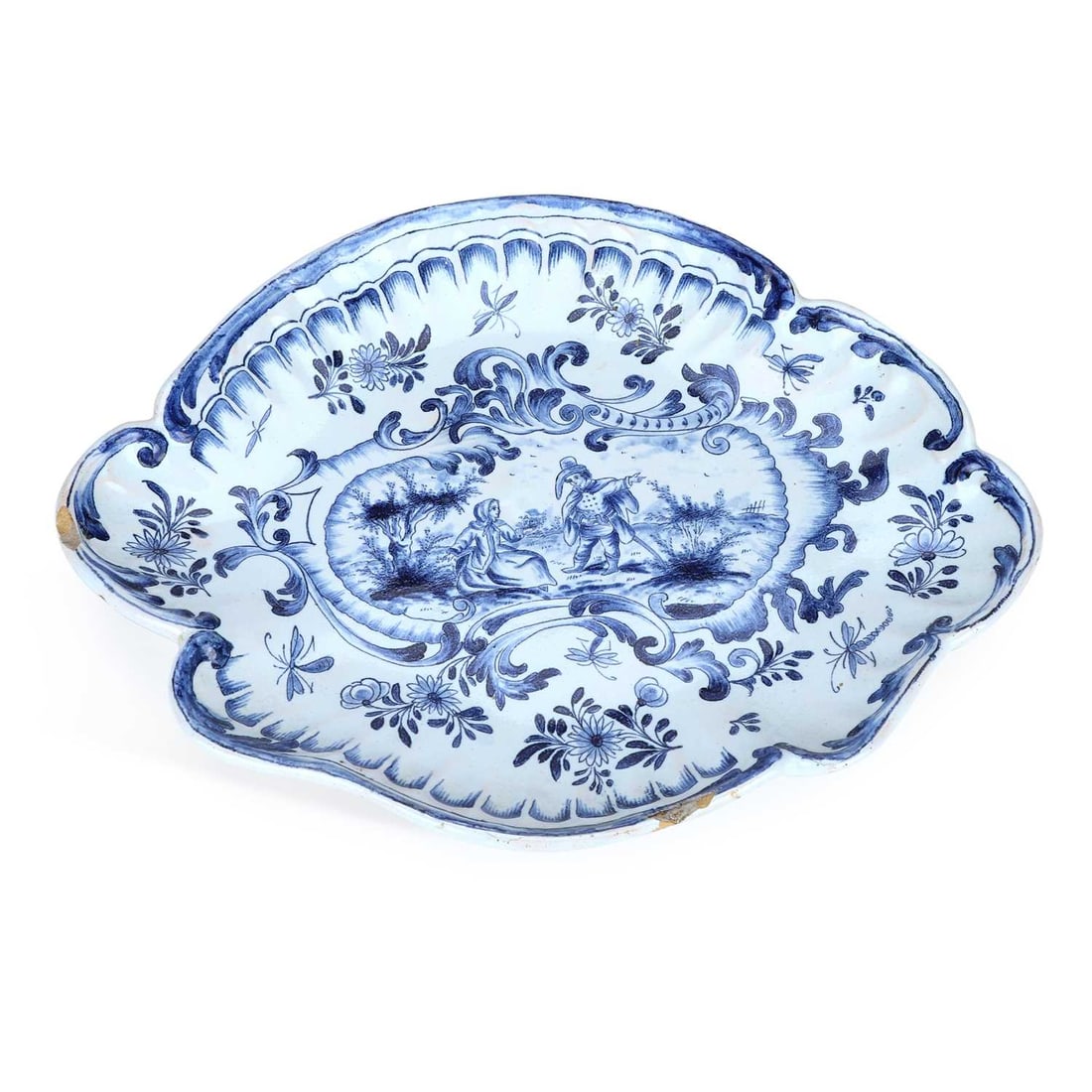 A FRENCH FAIENCE TUREEN STAND 19TH CENTURY: A FRENCH FAIENCE TUREEN STAND 19TH CENTURY painted to the centre with a male and female in a rustic landscape, with a scrolling blue painted surround, HDK mark. 26.5cm wide