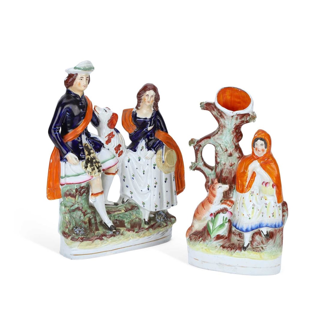 TWO VICTORIAN STAFFORDSHIRE POTTERY FIGURES CIRCA 1860: TWO VICTORIAN STAFFORDSHIRE POTTERY FIGURES CIRCA 1860 the first modelled as Red Riding Hood with the wolf, before a tree spill vase; the second, as a Highland couple accompanied by a dog. (2) Tallest