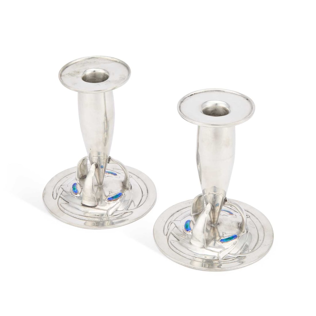 ARCHIBALD KNOX (1864-1933) FOR LIBERTY & CO, A PAIR OF TUDRIC PEWTER AND ENAMEL CANDLESTICKS (1 of 2)