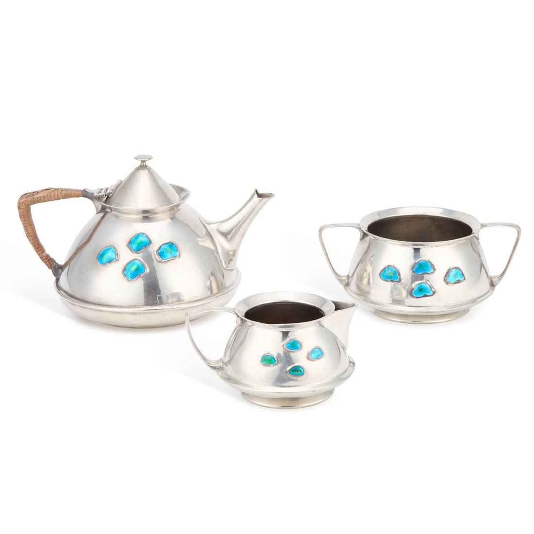 ARCHIBALD KNOX (1864-1933) FOR LIBERTY & CO, A THREE-PIECE TUDRIC PEWTER AND ENAMEL TEA SERVICE: ARCHIBALD KNOX (1864-1933) FOR LIBERTY & CO, A THREE-PIECE TUDRIC PEWTER AND ENAMEL TEA SERVICE comprising teapot, cream and two-handled sugar, each set with four unusual shape blue-green enamel plaqu