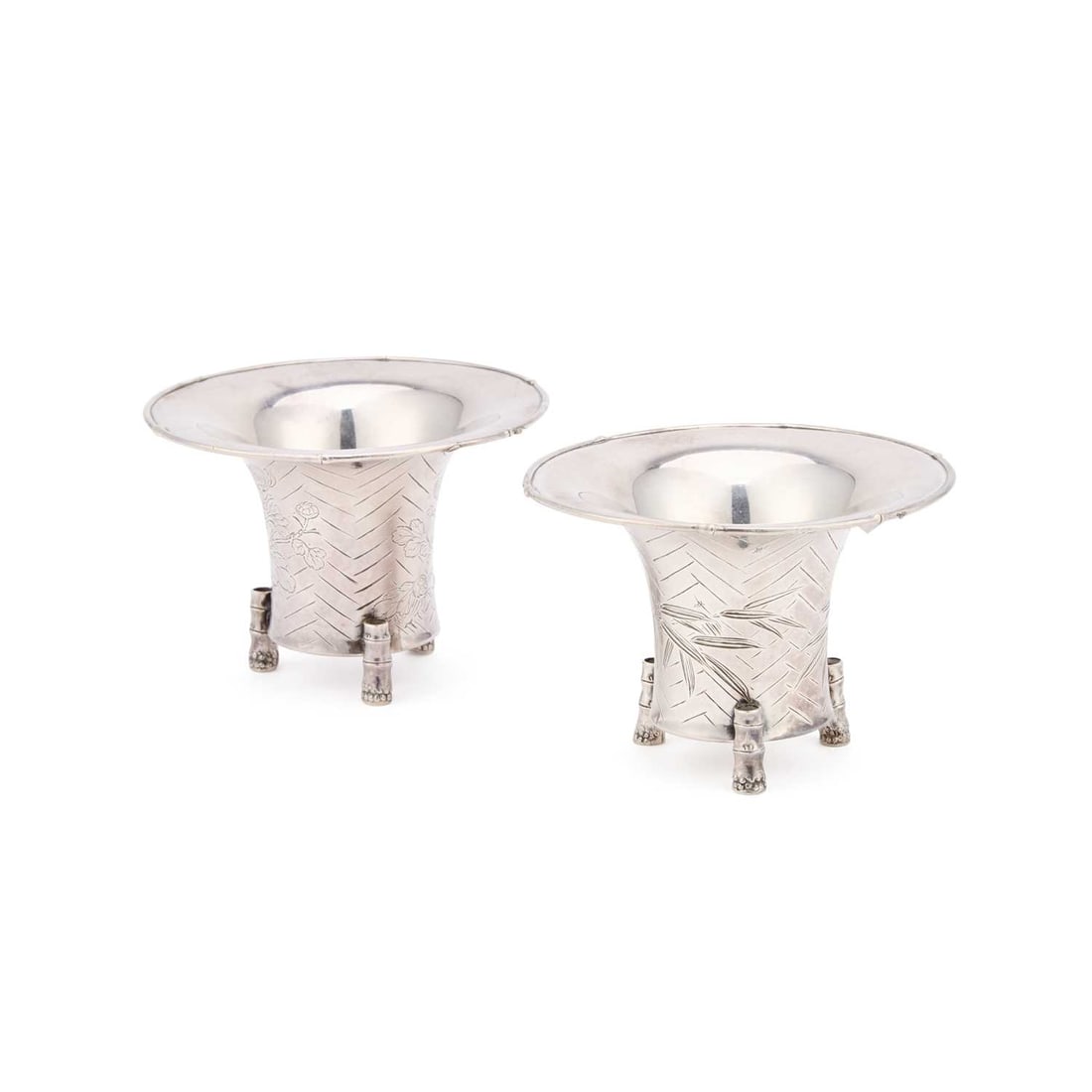 A PAIR OF EARLY 20TH CENTURY JAPANESE SILVER TRIPOD VASES: A PAIR OF EARLY 20TH CENTURY JAPANESE SILVER TRIPOD VASES each signed on the underside, of tapering cylindrical form with broad everted rims, each raised on three bamboo-moulded feet. (2) 6.5cm high, 