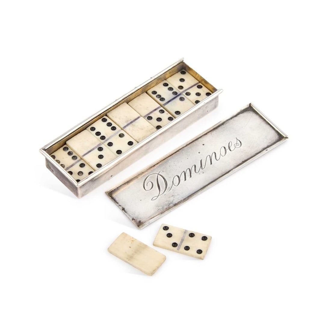 AN EDWARDIAN SILVER TRAVELLING DOMINOES BOX: AN EDWARDIAN SILVER TRAVELLING DOMINOES BOX by Cohen & Charles, Chester 1902, of typical rectangular form, with a sliding cover inscribed Dominoes in script, containing bone dominoes. Box 9cm