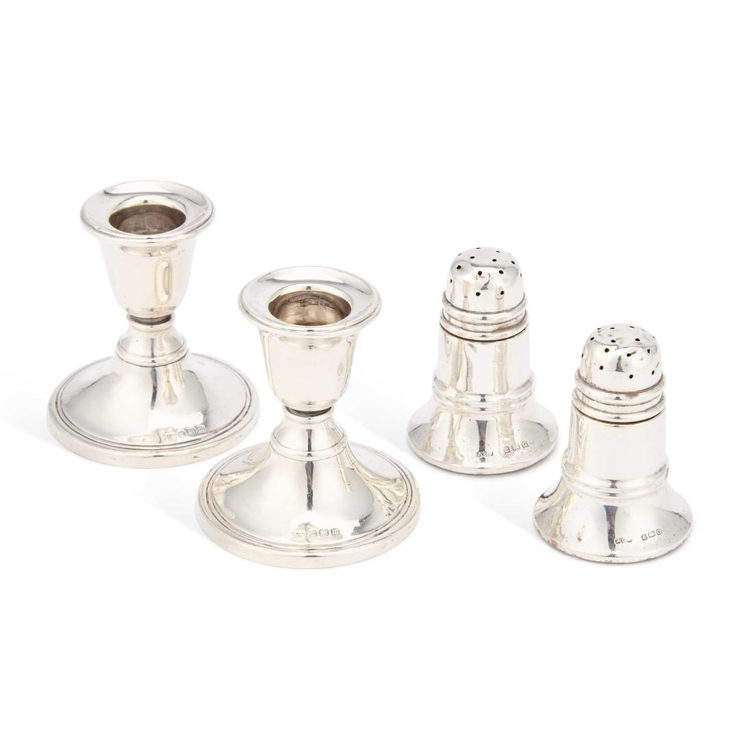 A PAIR OF GEORGE V SILVER DWARF CANDLESTICKS: A PAIR OF GEORGE V SILVER DWARF CANDLESTICKS by W J Myatt & Co, Birmingham 1911, filled; together with a pair of George V silver pepper pots, by A L Davenport Ltd, Birmingham 1931, weighted. (4) C