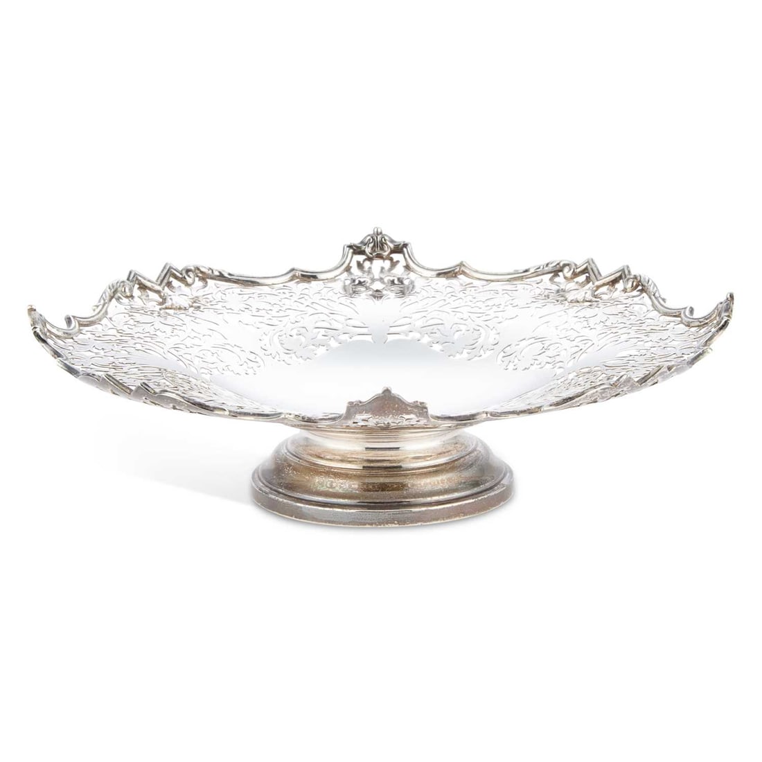 A GEORGE VI SILVER FRUIT DISH: A GEORGE VI SILVER FRUIT DISH by Walker & Hall, Sheffield 1937, of shaped circular form with a scroll pattern rim enclosing pierced sides. 25cm diameter, 12.3 troy ounces