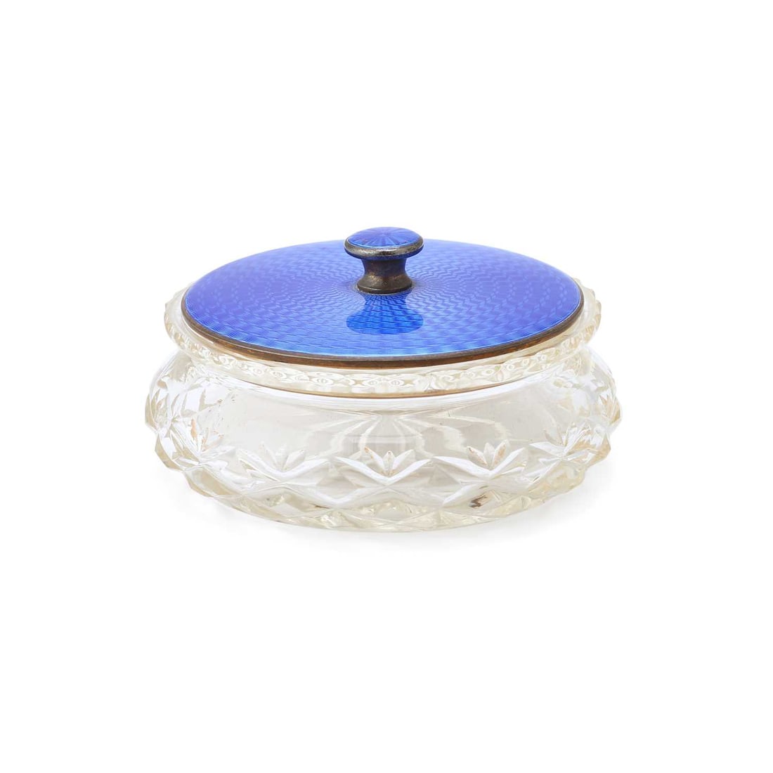 A GEORGE V SILVER AND ENAMEL TOPPED GLASS POWDER JAR: A GEORGE V SILVER AND ENAMEL TOPPED GLASS POWDER JAR by Henry Clifford Davis, Birmingham 1934, the circular cover decorated with blue guilloché enamel. 10cm diameter