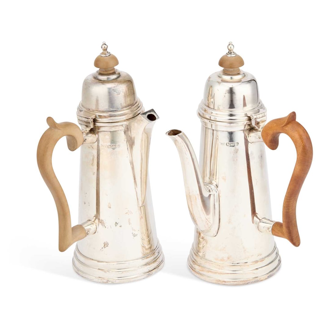 A PAIR OF GEORGE VI SILVER CAFE AU LAIT POTS: A PAIR OF GEORGE VI SILVER CAFE AU LAIT POTS by Walker & Hall, Sheffield 1938, each of tapering cylindrical form with domed covers. (2) 21cm high, 22.6 troy ounces gross