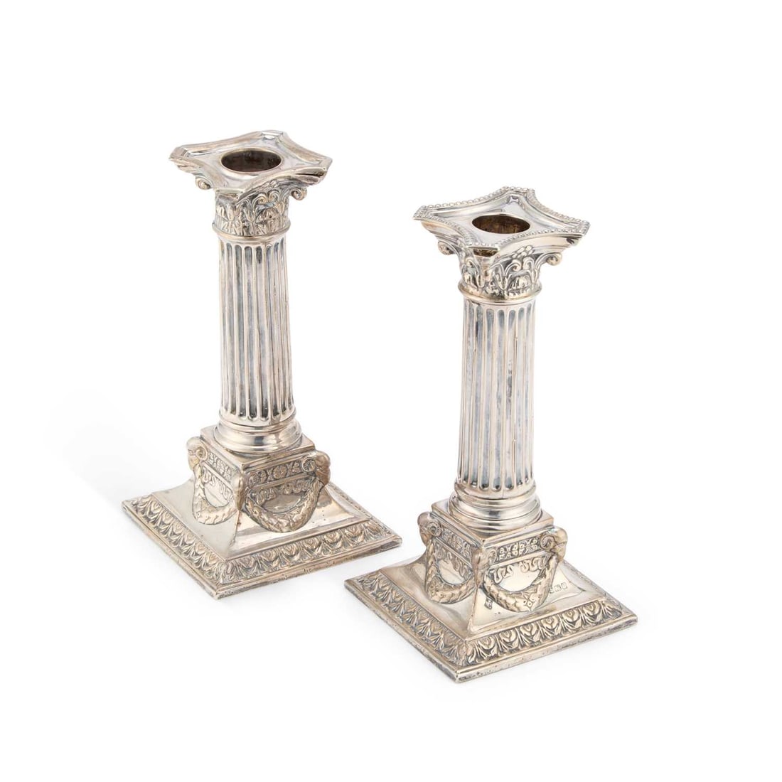 A NEAR PAIR OF EARLY 20TH CENTURY SILVER COLUMNAR CANDLESTICKS: A NEAR PAIR OF EARLY 20TH CENTURY SILVER COLUMNAR CANDLESTICKS by Martin, Hall & Co (Richard Martin & Ebenezer Hall), Birmingham, 1907 and 1911, each Corinthian column issuing from a square, s