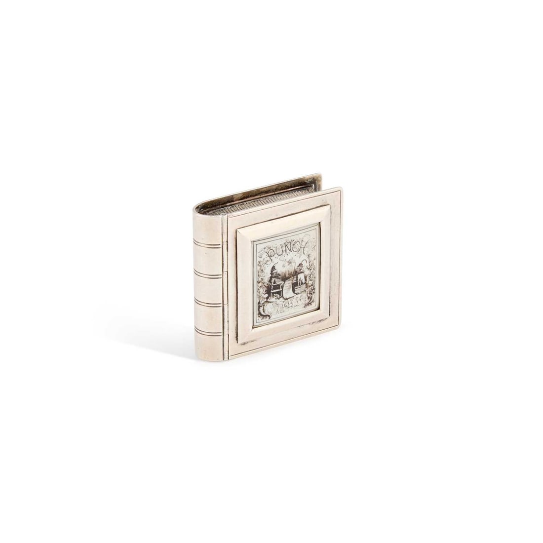 A VICTORIAN SILVER AND ENAMEL NOVELTY VESTA CASE: A VICTORIAN SILVER AND ENAMEL NOVELTY VESTA CASE by Albert William Barker, London 1887, in the form of a book, the lid with monochrome enamelling of 'PUNCH' with scene of Mr Punch and Judy the Dog bel