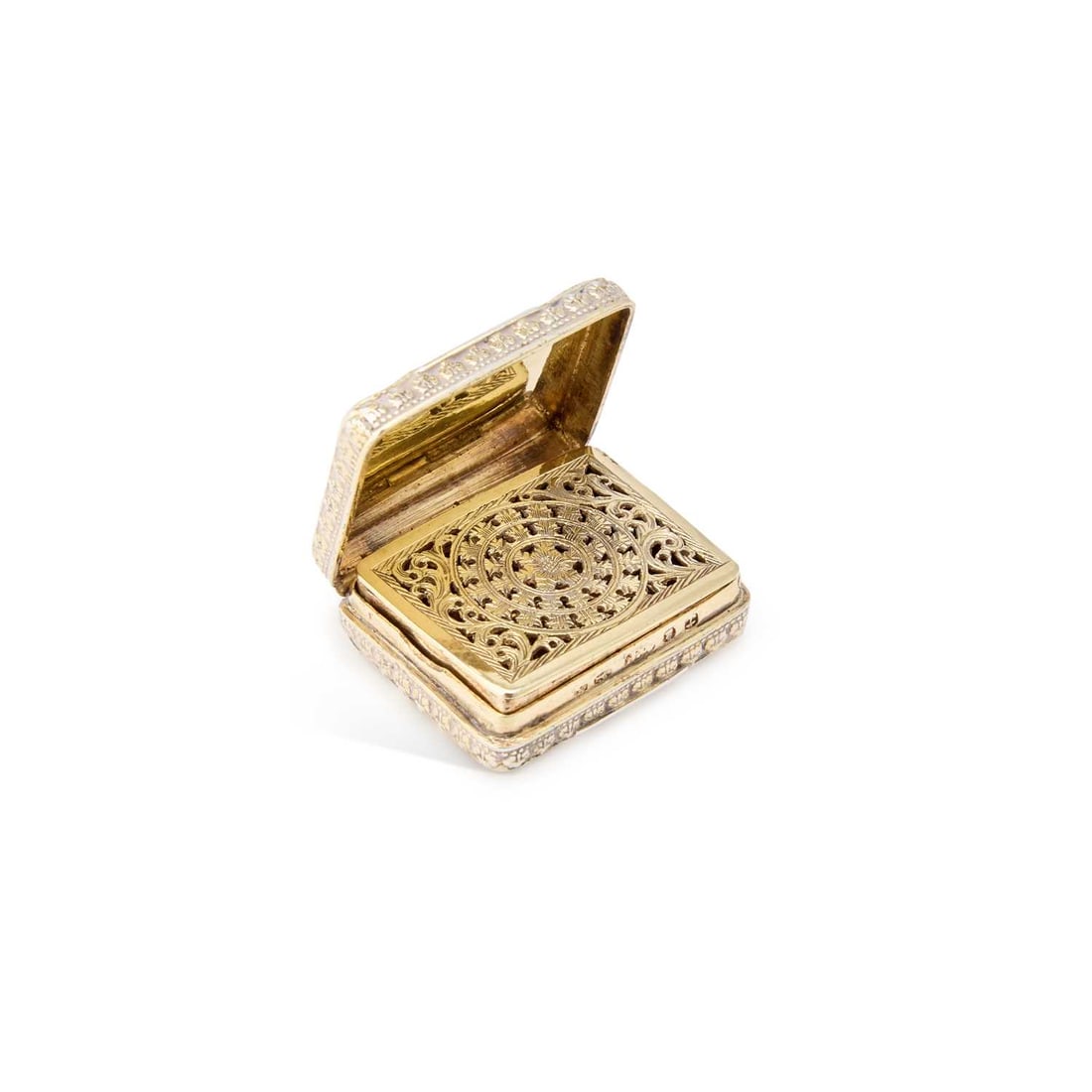 A GEORGE IV SILVER-GILT VINAIGRETTE: A GEORGE IV SILVER-GILT VINAIGRETTE by Joseph Willmore, Birmingham 1821, of rectangular form, the cover and base decorated with Vitruvian scroll, the interior with a pierced grille engraved with a lar