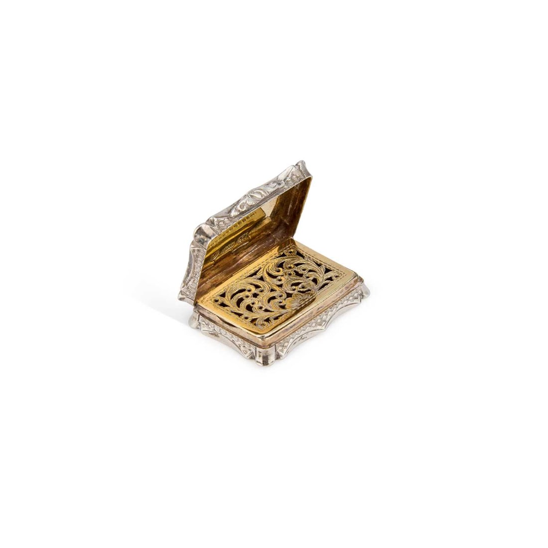 A GOOD EARLY VICTORIAN SILVER VINAIGRETTE: A GOOD EARLY VICTORIAN SILVER VINAIGRETTE by Nathaniel Mills, Birmingham 1844, of shaped rectangular form with an engine-turned cover and base, the gilt interior with a pierced and foliate engraved gr