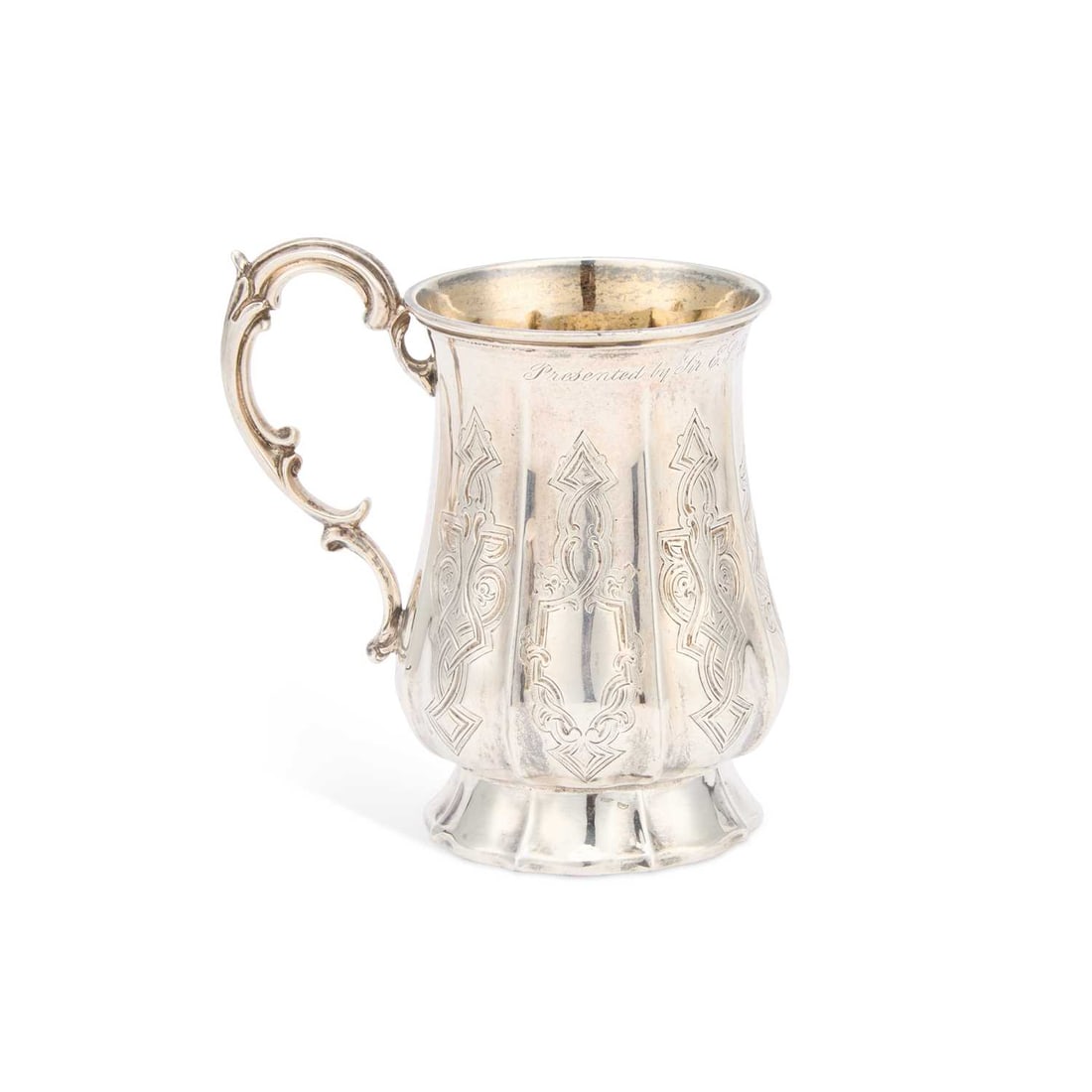 A VICTORIAN SILVER MUG: A VICTORIAN SILVER MUG by Daniel & Charles Houle, London 1865, of panelled baluster form with a scroll-form handle, chased with arabesques, presentation inscription dated 1868. 12cm high, 6.3 troy