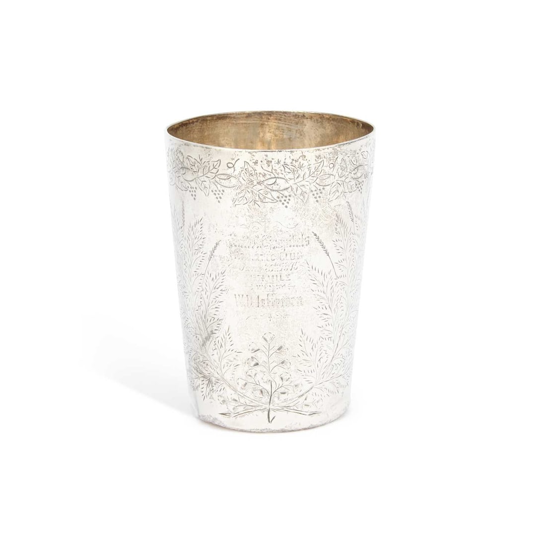 A VICTORIAN SILVER BEAKER: A VICTORIAN SILVER BEAKER by Thomas Smily, London 1874, of tapering cylindrical form with engraved foliate decoration and presentation inscription. 10.5cm high, 4 troy ounces