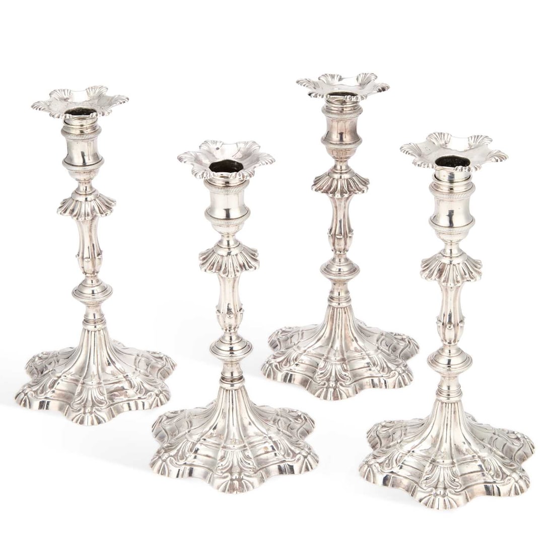 A SET OF FOUR EARLY GEORGE III CAST SILVER CANDLESTICKS (1 of 4)
